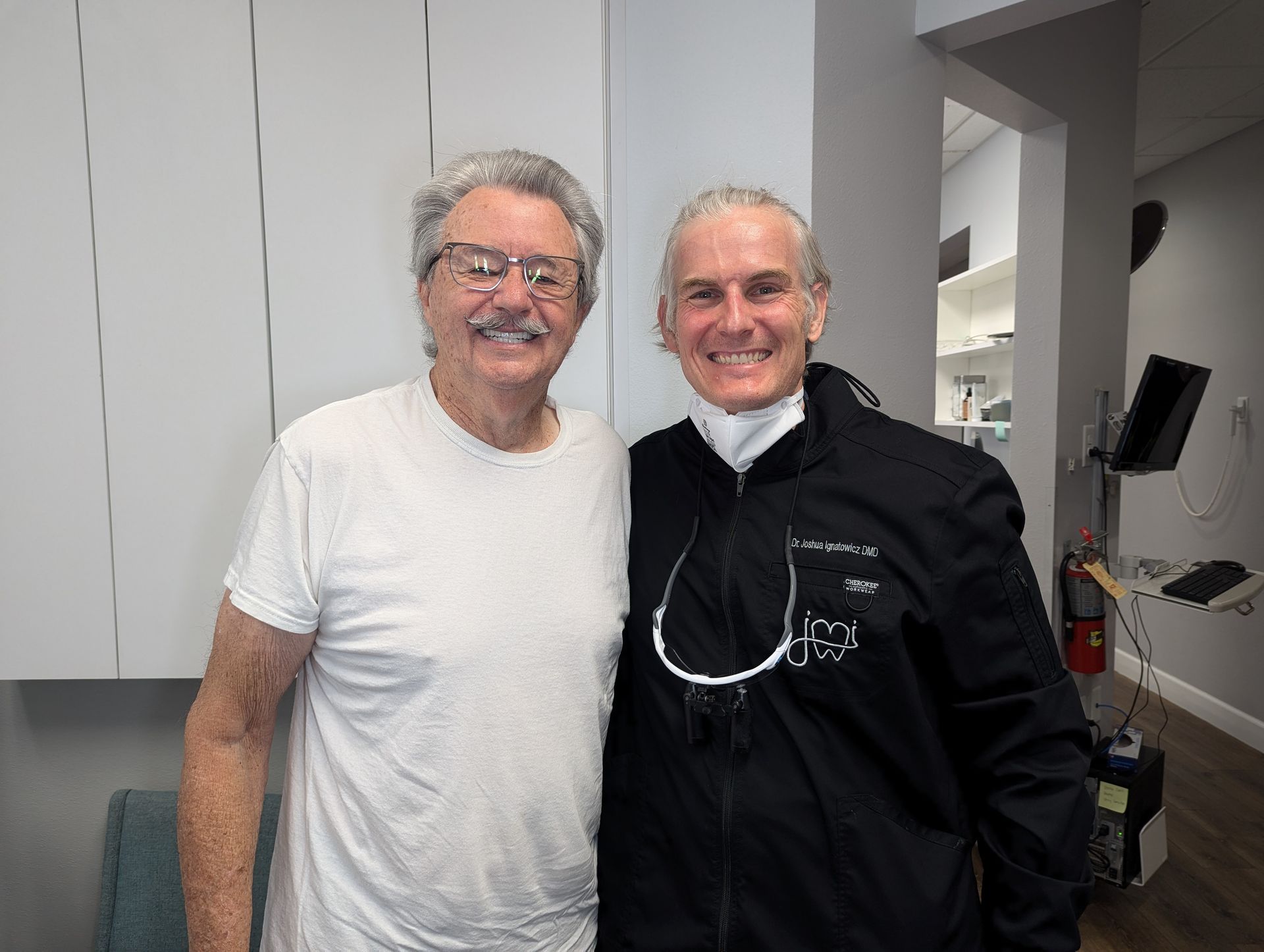 Dr. Joshua Ignatowicz smiling with a patient in the dental office