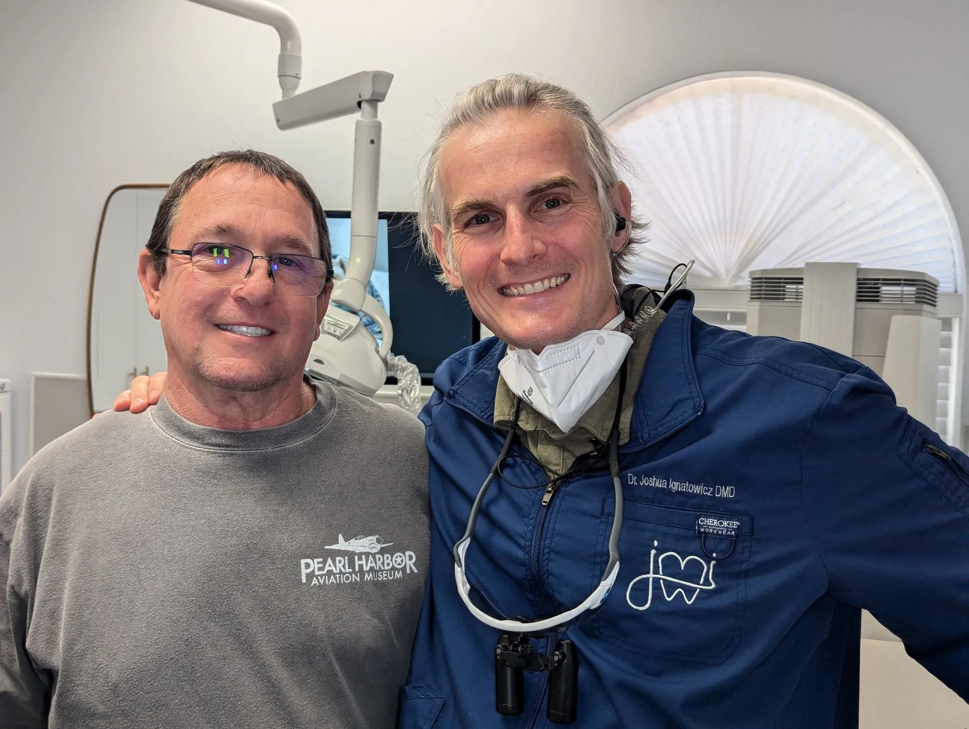 Dr. Joshua Ignatowicz smiling with a patient in the dental office