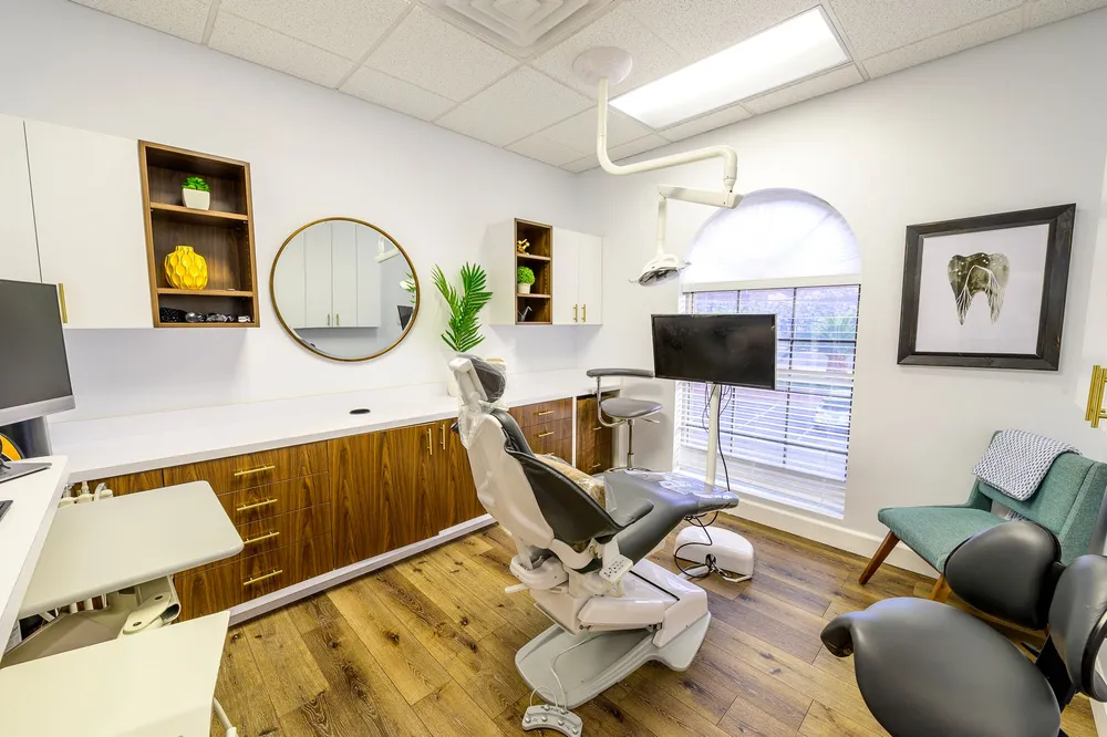 Bright dental exam room with a mirror on the wall at Joshua M. Ignatowicz DMD and Associates