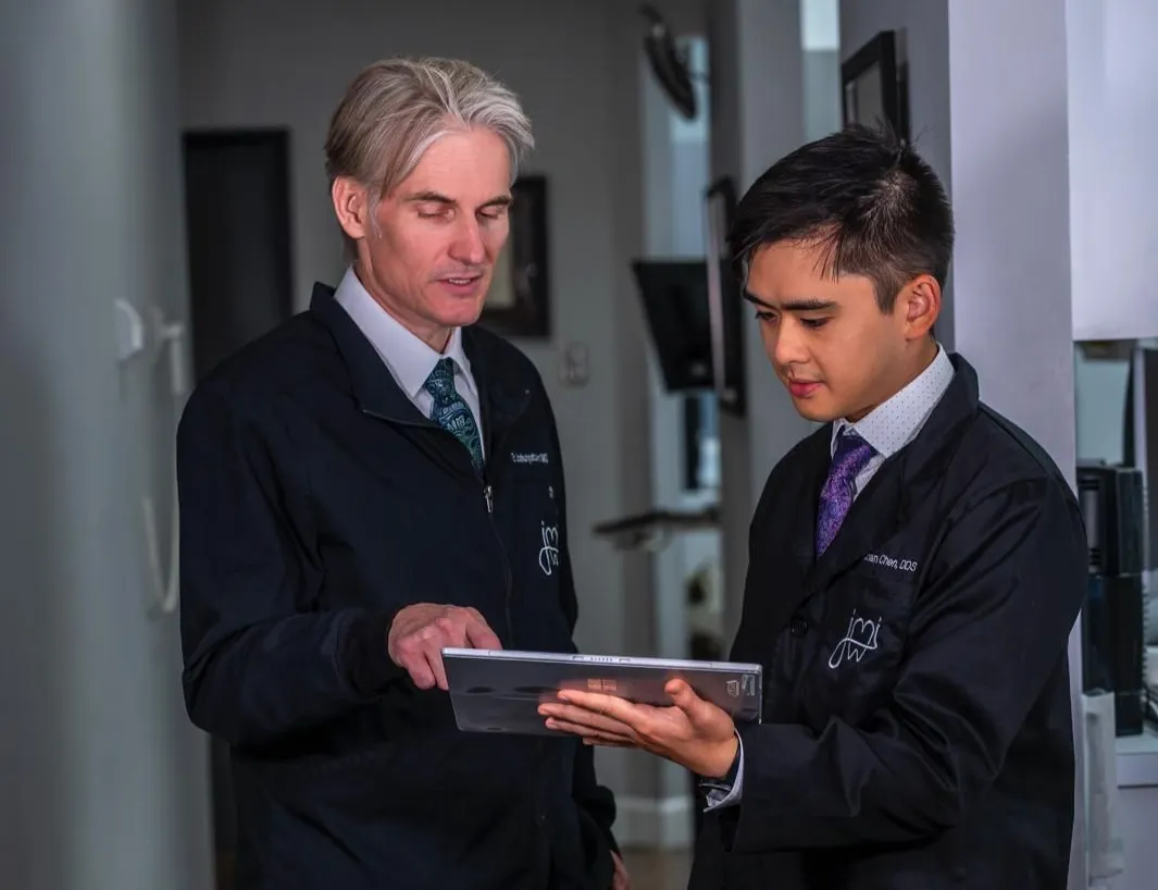 Dr. Joshua Ignatowicz and Dr. Nathan Chen reviewing patient information on a tablet