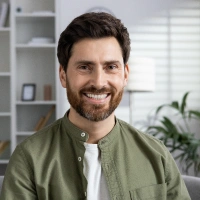 Male patient smiling after receiving emergency dental care