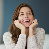 Young woman smiling confidently after restorative dental treatment